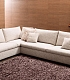 Стильный угловой диван с подушками и боковой панелью с полками в гостиную LAZAR