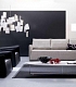 Светлый диван и два черных кожаных кресла в гостиной ANTARES
